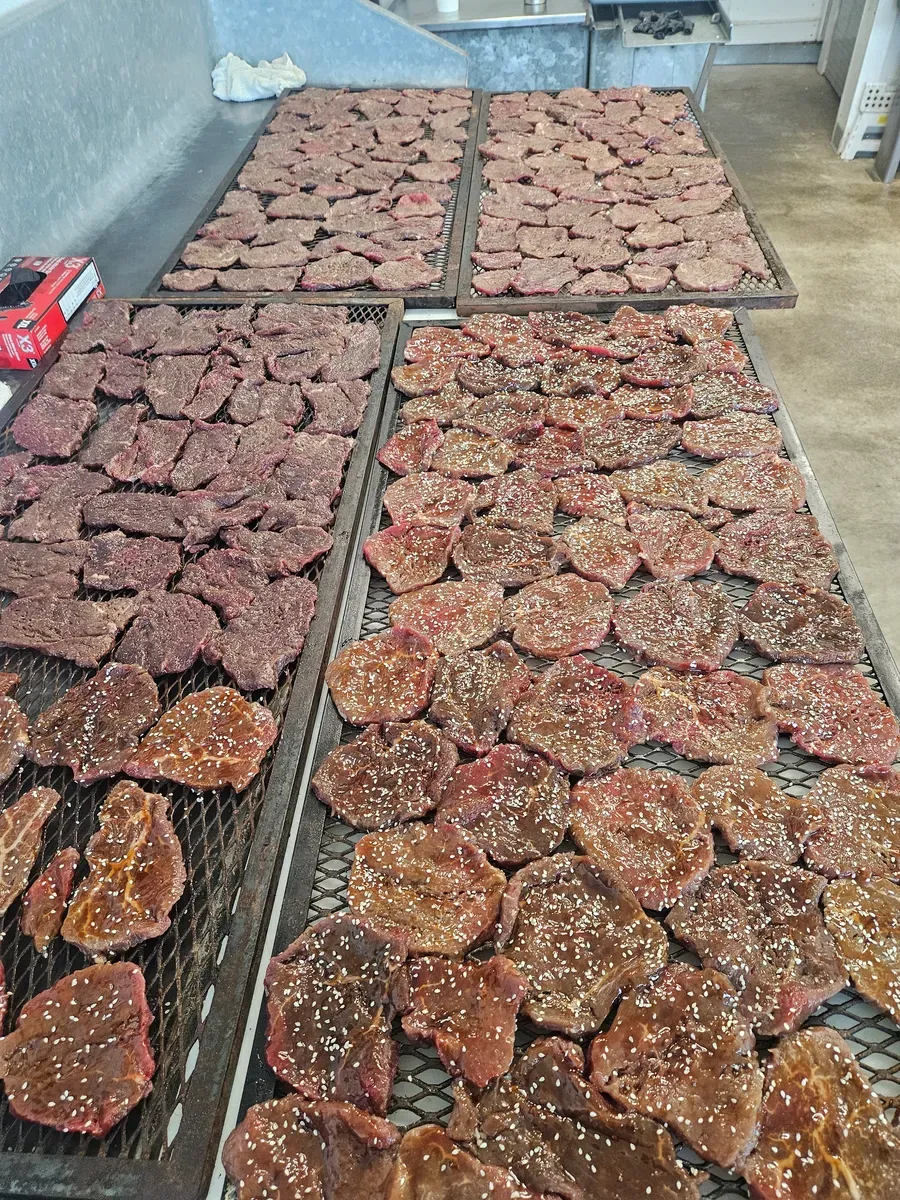 Racks of homemade beef jerky drying at H&M Custom Meat's facility in Creston, WA