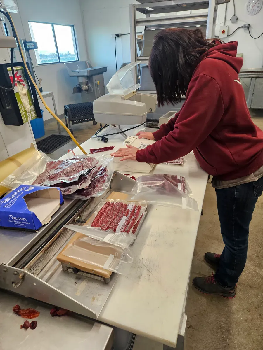 Beef sticks and jerky being vacuum sealed at H&M Custom Meat in Creston, WA