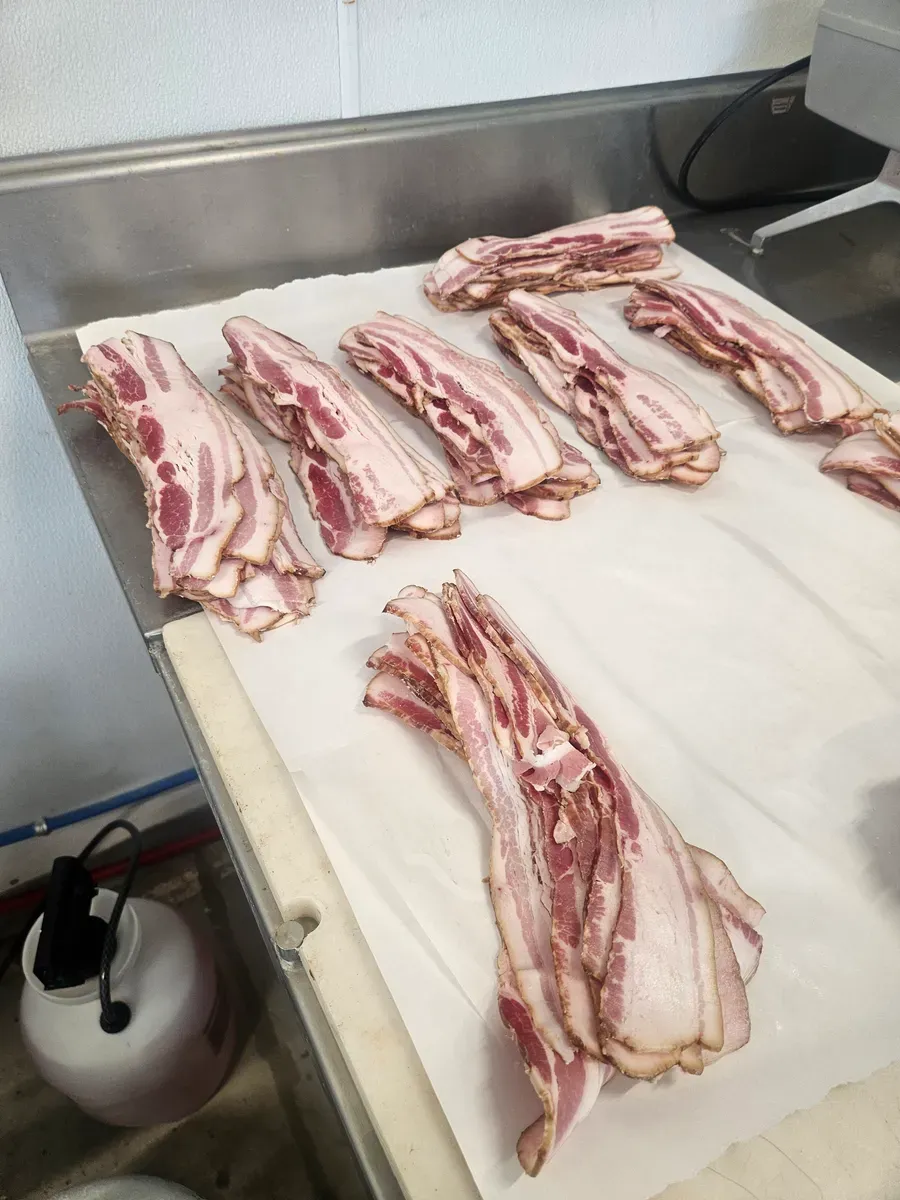 Hand-cut thick slices of custom smoked bacon from H&M Custom Meat's pork processing