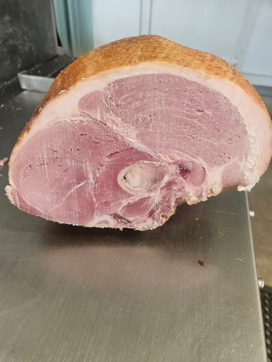 Cross-section of a perfectly smoked and cured ham showing the pink center at H&M Custom Meat